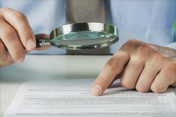man reading a will with a magnifying glass